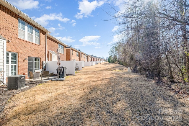 view of yard featuring a patio and central AC