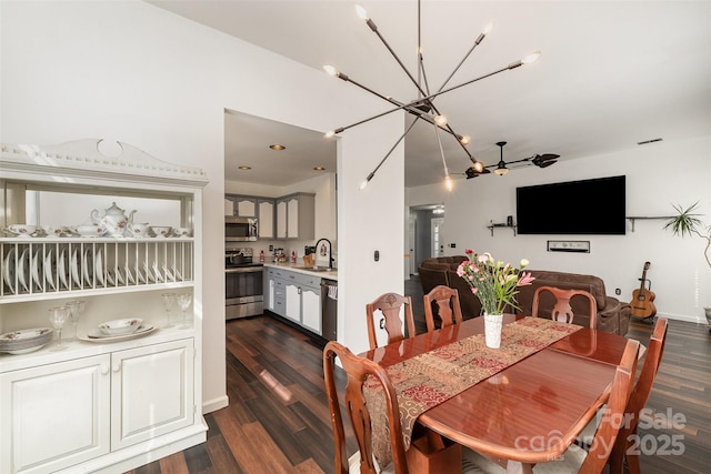 dining room featuring an inviting chandelier, dark hardwood / wood-style floors, and sink