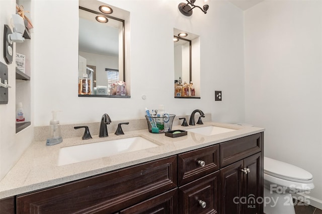 bathroom featuring vanity and toilet