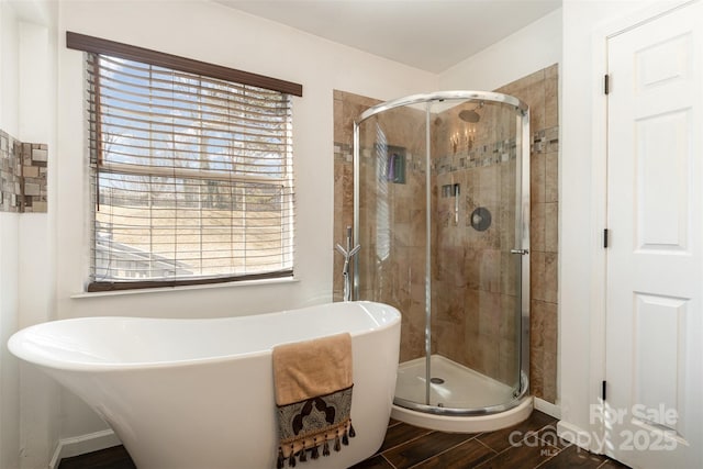 bathroom with hardwood / wood-style flooring and shower with separate bathtub