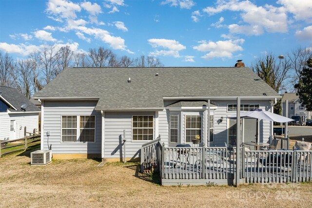 back of house featuring a wooden deck, a yard, and cooling unit