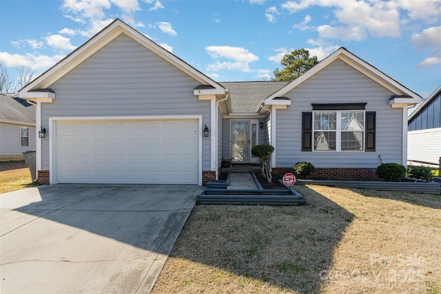 view of front of property featuring a garage and a front lawn