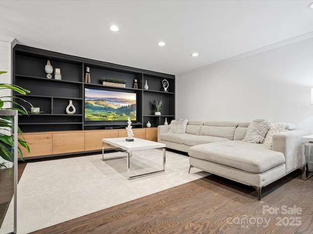 living room with dark hardwood / wood-style flooring and crown molding