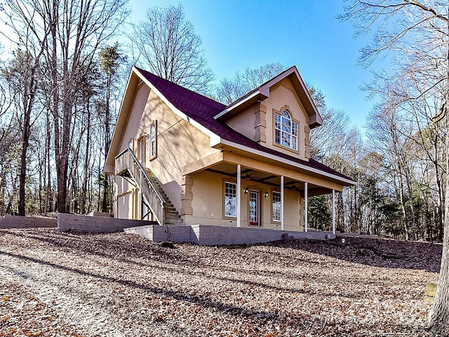 view of front of home with ceiling fan and a porch