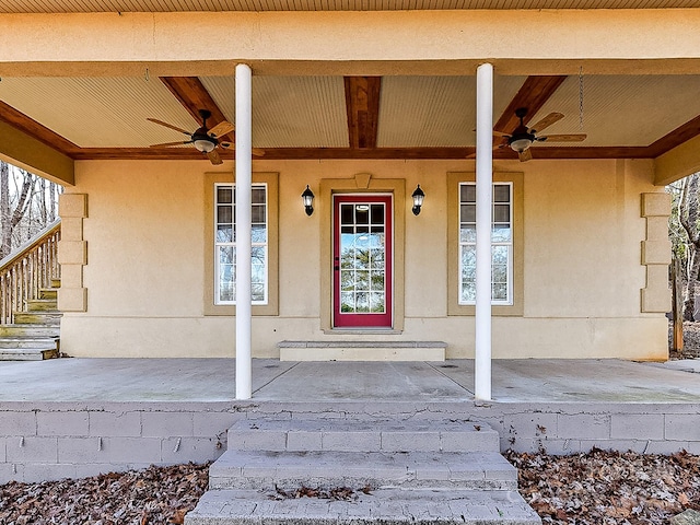 entrance to property featuring ceiling fan