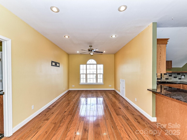 unfurnished living room with ceiling fan and light wood-type flooring