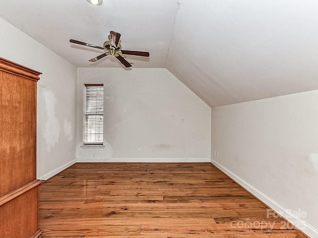 additional living space featuring wood-type flooring, ceiling fan, and vaulted ceiling