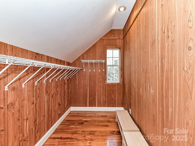 spacious closet featuring hardwood / wood-style flooring and vaulted ceiling