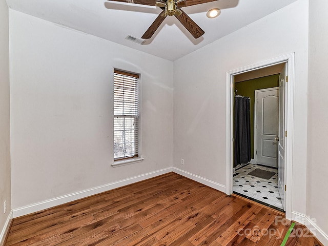 empty room featuring hardwood / wood-style flooring and ceiling fan