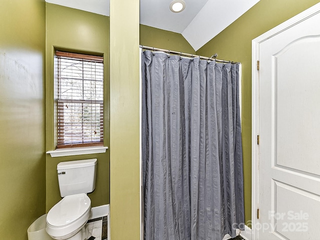 bathroom featuring toilet and a shower with shower curtain