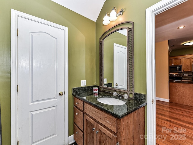 bathroom with vanity and wood-type flooring