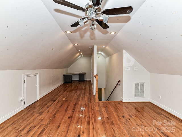 additional living space featuring hardwood / wood-style flooring and vaulted ceiling