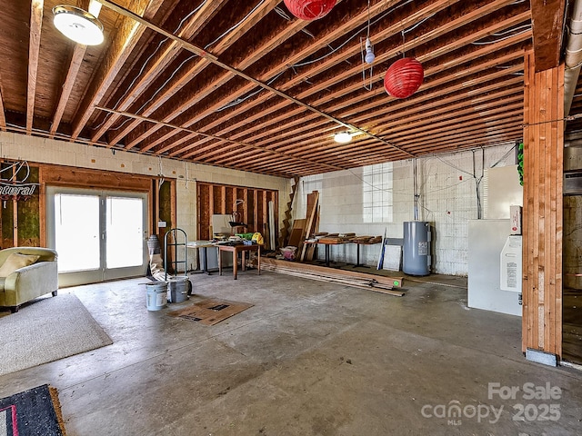 misc room with concrete flooring and water heater