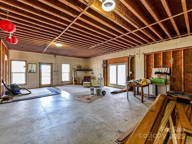 miscellaneous room with a wealth of natural light and concrete floors