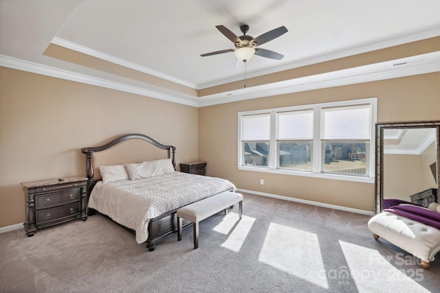 carpeted bedroom featuring ceiling fan, ornamental molding, and a tray ceiling