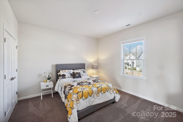 bedroom with dark colored carpet