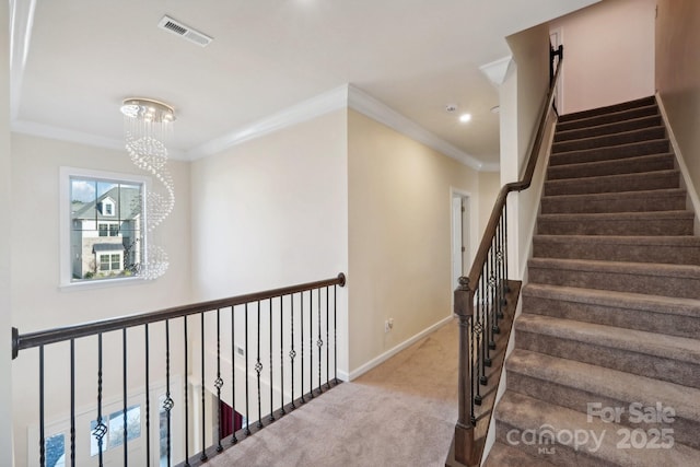 staircase featuring crown molding, carpet, and an inviting chandelier