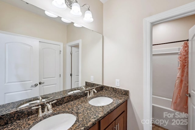 bathroom with shower / tub combo with curtain and vanity