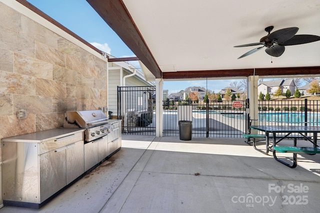 view of patio / terrace featuring ceiling fan, area for grilling, grilling area, and a fenced in pool