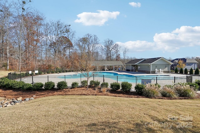 view of pool featuring a lawn and a patio