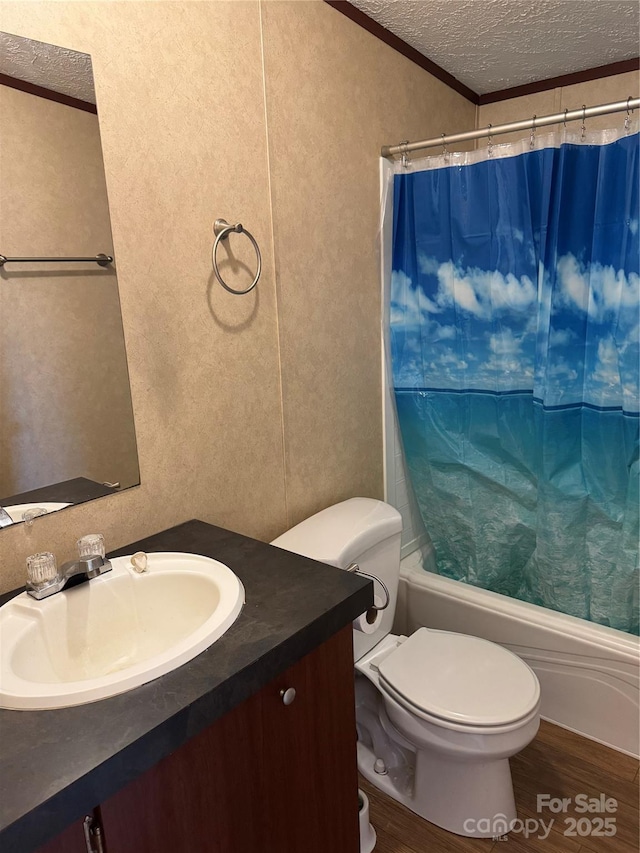 full bathroom featuring hardwood / wood-style floors, vanity, toilet, crown molding, and a textured ceiling