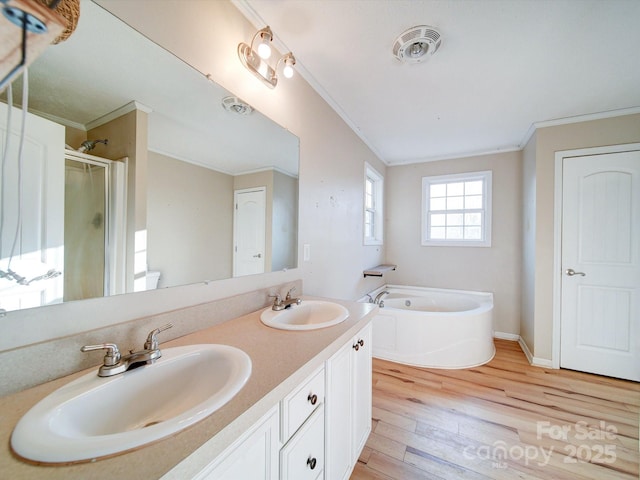 bathroom with vanity, crown molding, separate shower and tub, and hardwood / wood-style flooring