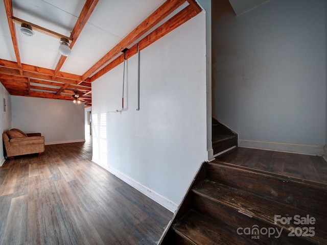 stairs with coffered ceiling, ceiling fan, wood-type flooring, and beam ceiling