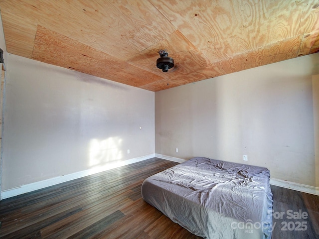 unfurnished bedroom featuring dark hardwood / wood-style flooring and wood ceiling