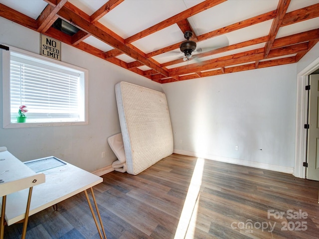 interior space featuring ceiling fan, coffered ceiling, dark hardwood / wood-style flooring, and beam ceiling