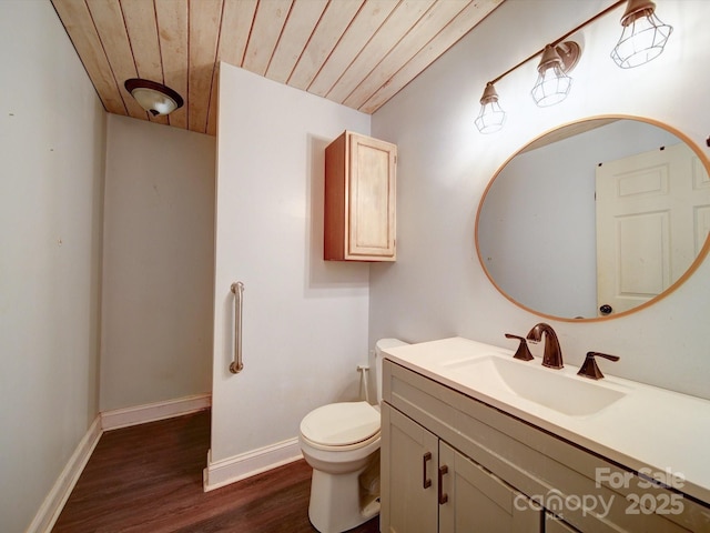 bathroom featuring hardwood / wood-style flooring, vanity, wooden ceiling, and toilet