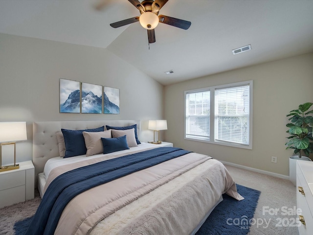 bedroom with lofted ceiling, baseboards, visible vents, and light carpet