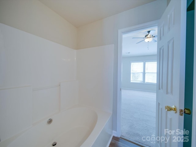 bathroom featuring a ceiling fan and baseboards