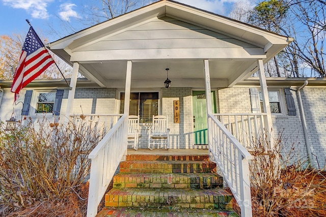 view of exterior entry featuring a porch