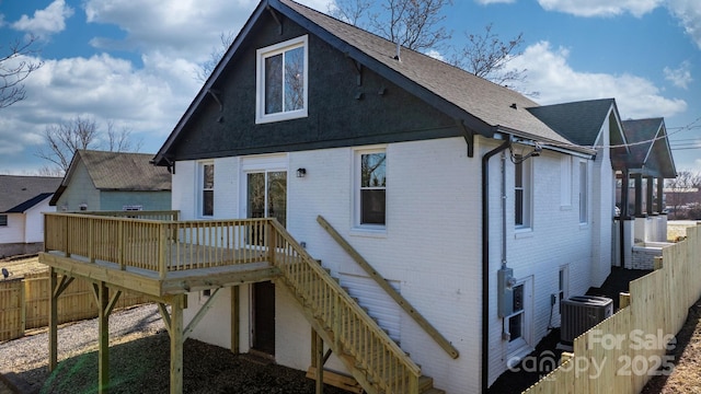 rear view of property featuring central AC and a deck