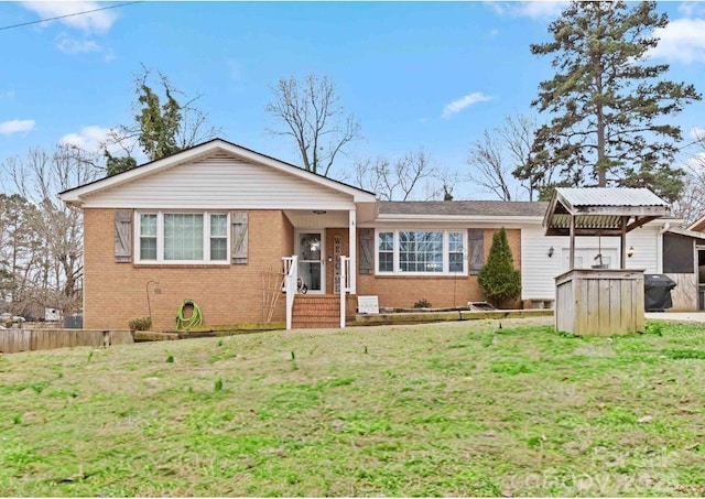 single story home with a front lawn and brick siding