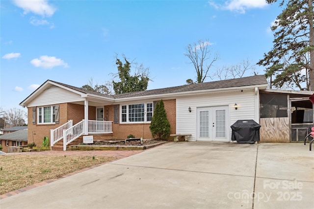 single story home with brick siding and french doors