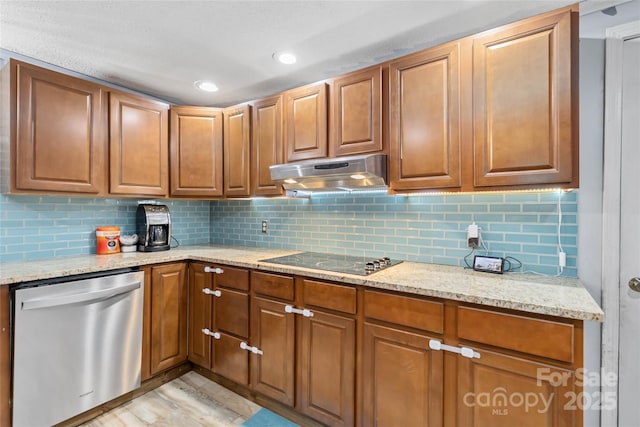 kitchen featuring light stone counters, stainless steel dishwasher, black electric cooktop, and under cabinet range hood