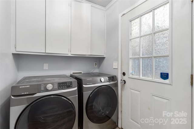 clothes washing area with washer and clothes dryer and cabinet space