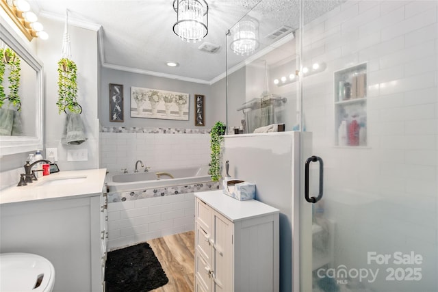 full bath with visible vents, wood finished floors, crown molding, a shower stall, and a bath