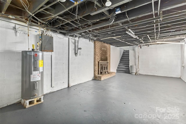 unfinished basement with electric panel, stairway, and electric water heater