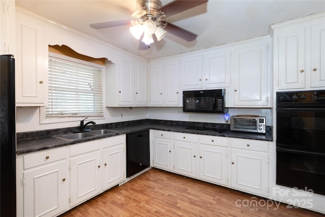 kitchen with a toaster, a sink, white cabinets, black appliances, and dark countertops