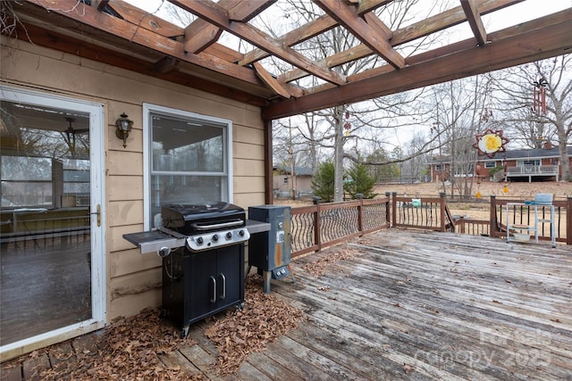 wooden deck with area for grilling and a pergola