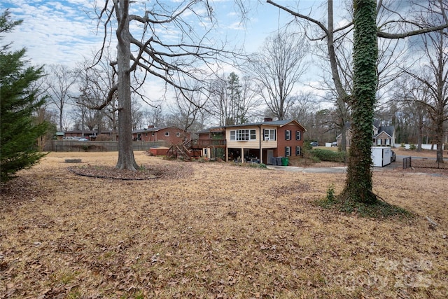 view of yard featuring stairway, a wooden deck, and fence