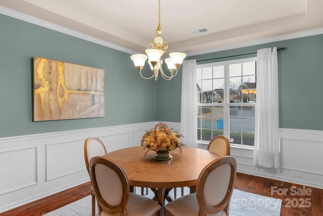 dining area featuring hardwood / wood-style floors and a chandelier