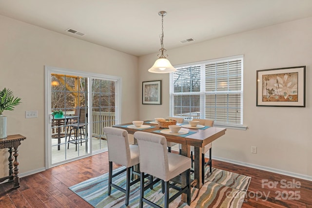 dining area featuring dark wood-type flooring