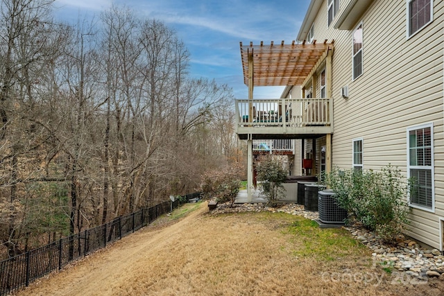 view of yard with central AC unit and a pergola