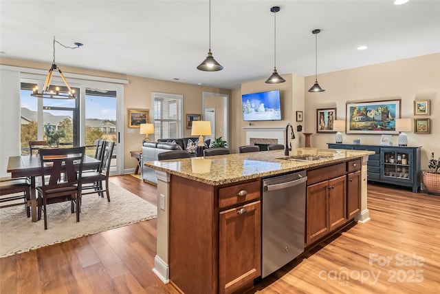 kitchen featuring dishwasher, sink, and decorative light fixtures