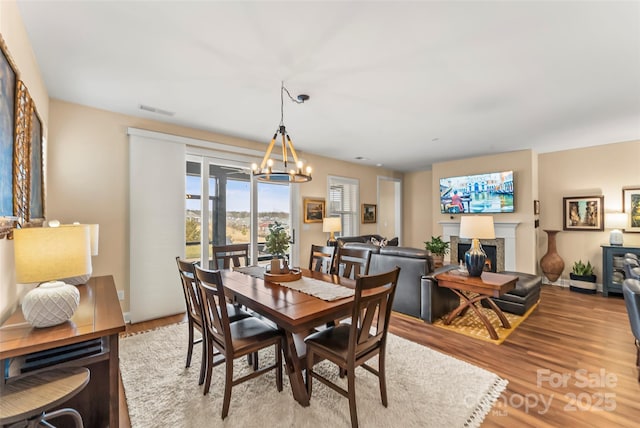 dining room with a chandelier and light hardwood / wood-style flooring