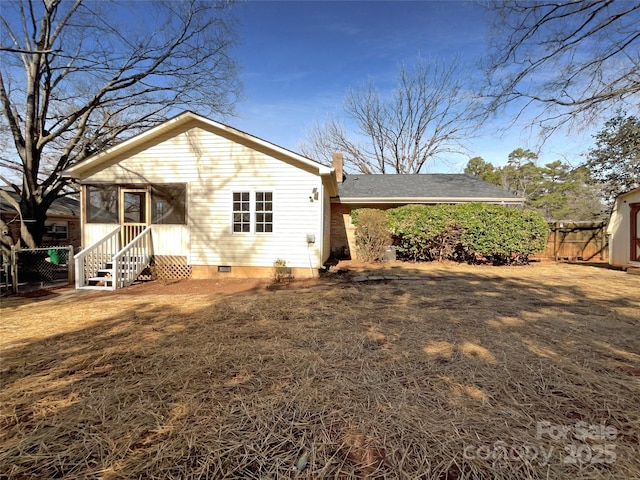 back of property with a sunroom