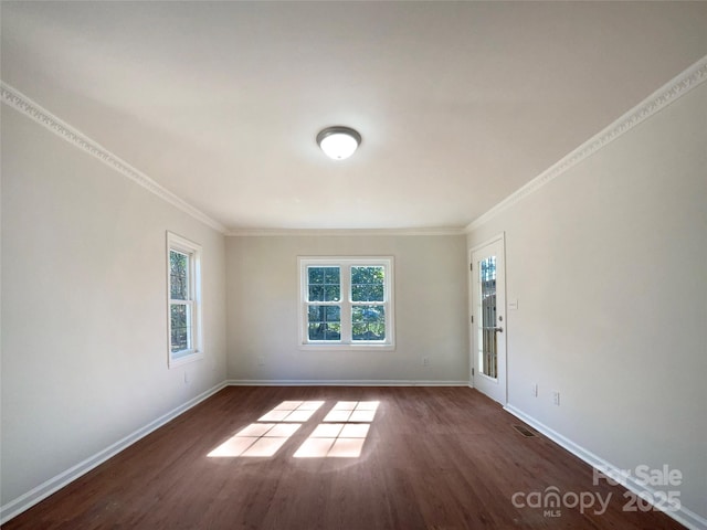 empty room with dark wood-type flooring and ornamental molding